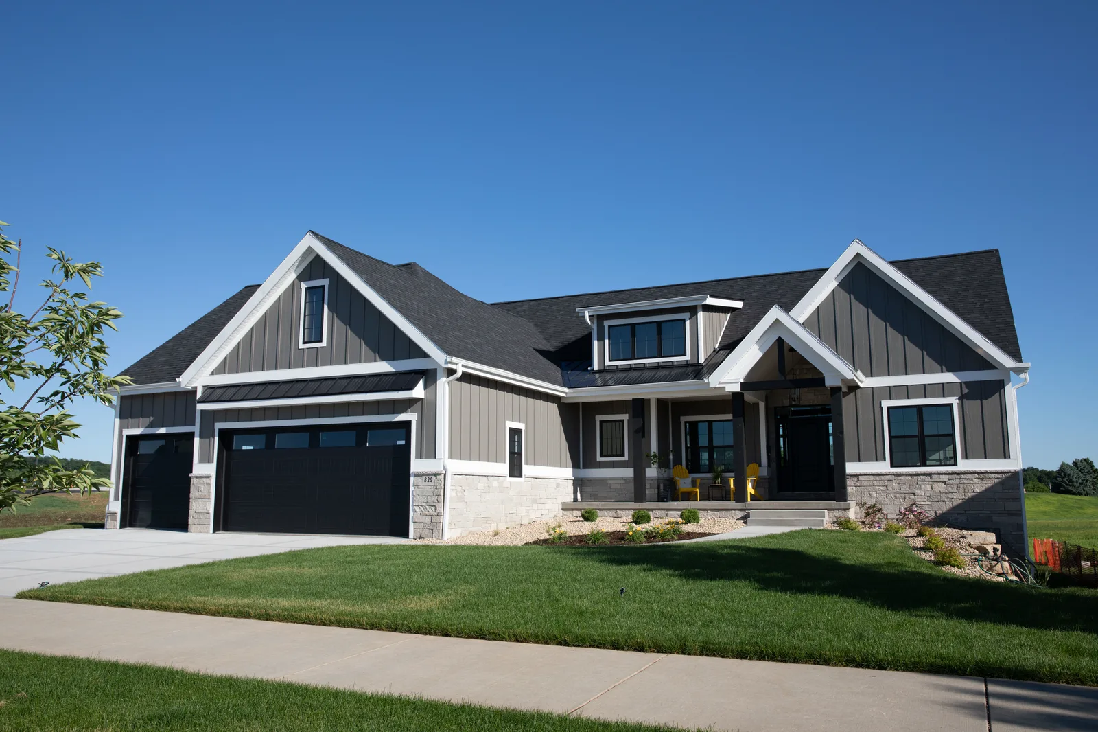 House with new dark grey board-and-batten and lap siding