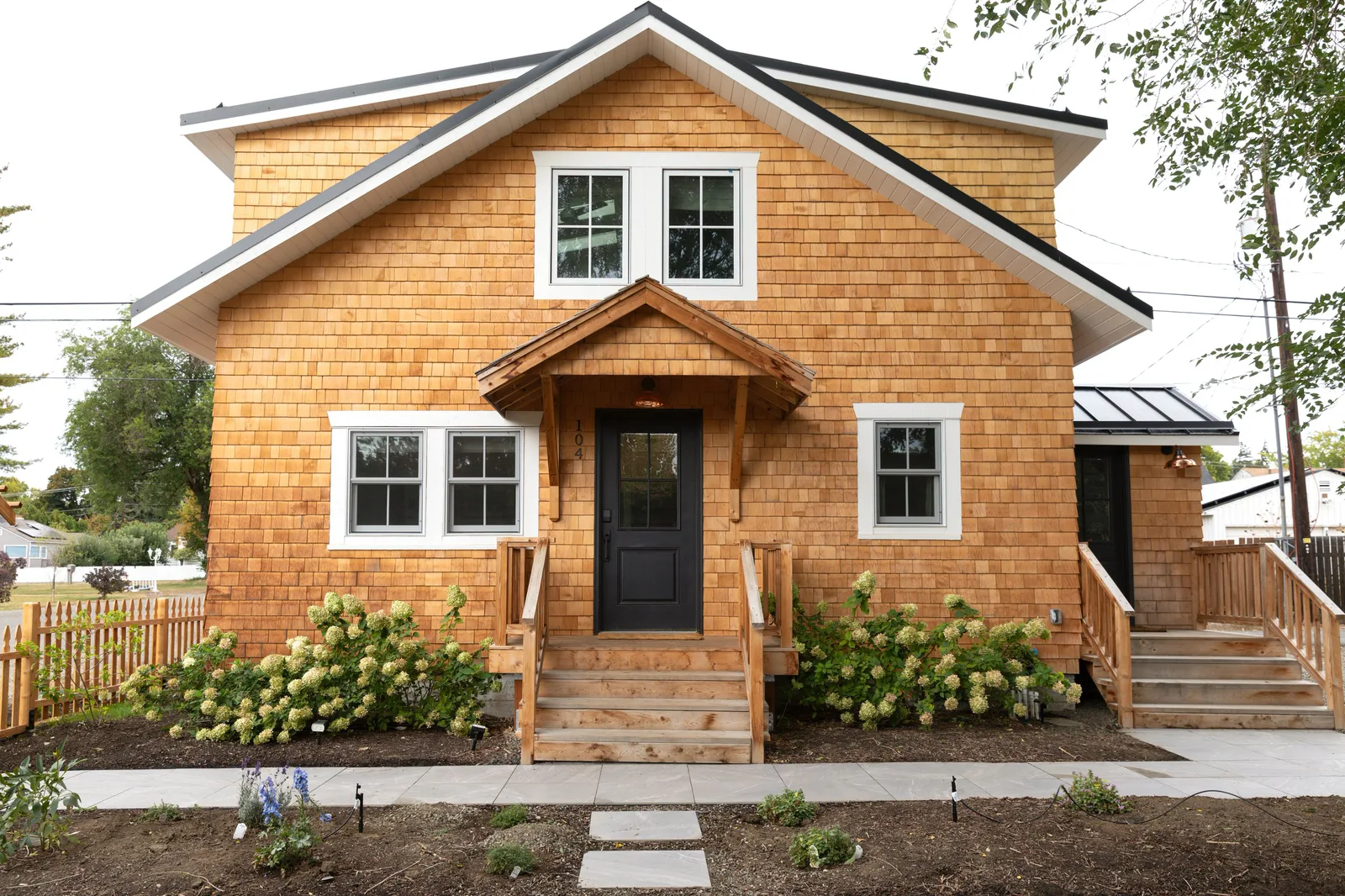 Home with new cedar shingle siding and white trim
