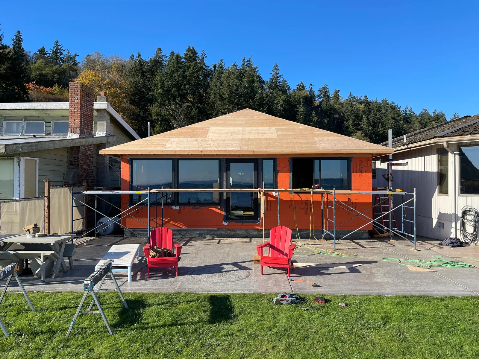 Beachfront cottage mid-remodel with new roof sheathing, new windows and house wrap