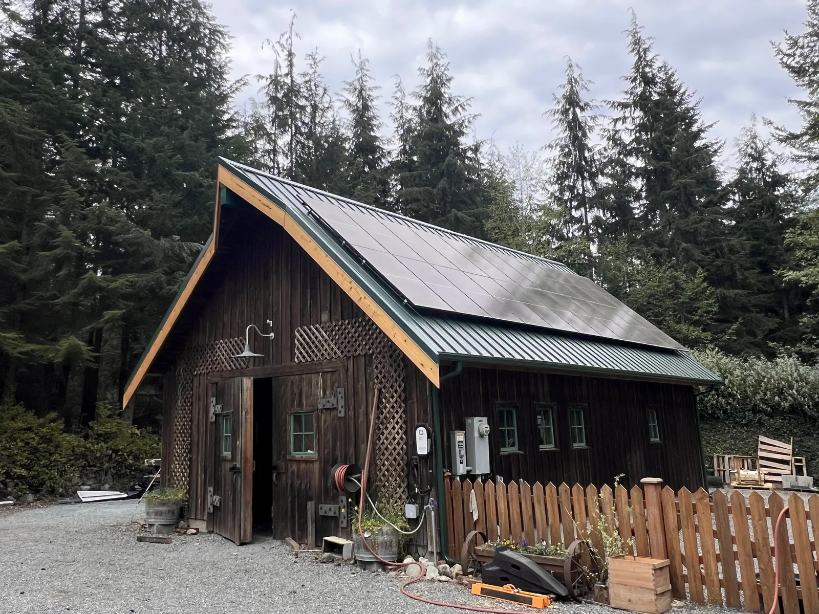 Standing-seam metal roof with solar panels on a cedar barn on Whidbey Island
