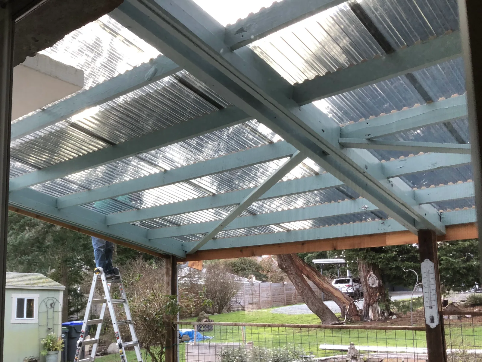 Translucent roof panels going onto a new patio cover frame, seen from underneath